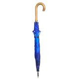 A closed royal blue umbrella with a curved natural wood handle.