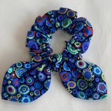 Blue patterned scrunchie on a white background