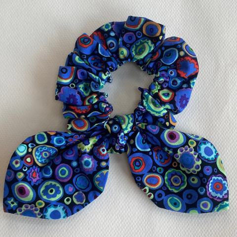 Blue patterned scrunchie on a white background