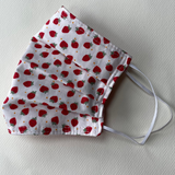 Fabric face mask with red and white strawberry pattern on a white background