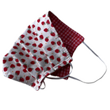 Red and white strawberry patterned fabric mask on a white background