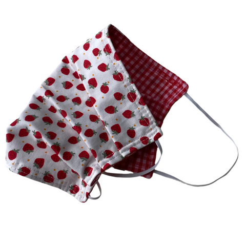 Red and white strawberry patterned fabric mask on a white background