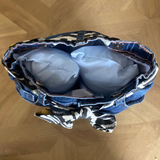 Blue denim door stop, open on a wooden floor