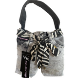 Handbag made from repurposed jeans with a zebra pattern ribbon and visible brand tag.
