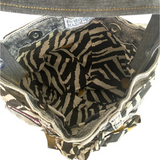 Open bag with zebra pattern lining.