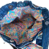 Colorful patterned fabric inside a denim bag 