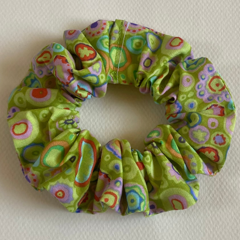Green patterned scrunchie on a light gray background