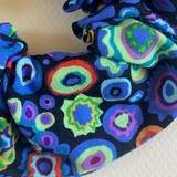 Colorful fabric with circular patterns on a plain background