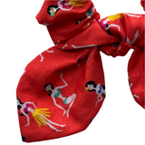 Red scrunchie with colorful designs on a white background