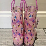 Pink rain boots with colorful patterns on a wooden floor.